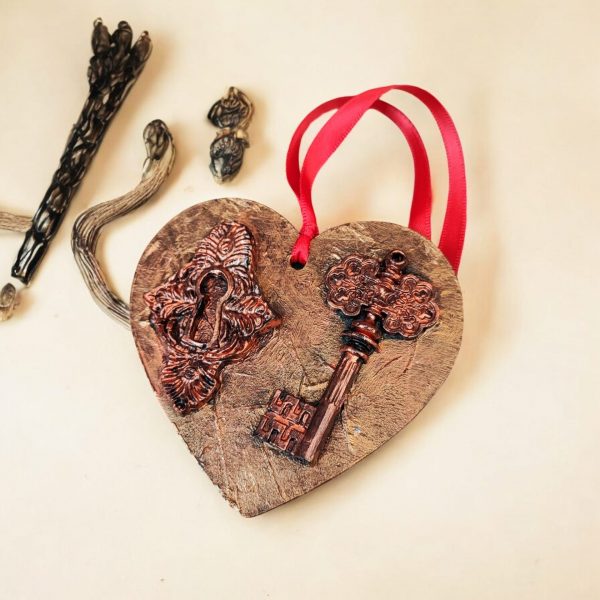 Hand-decorated hanging heart. Key and locker resin embellishments painted in a metallic cooper