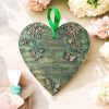 Green hanging heart decoration with flowers and butterflies