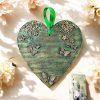 Green hanging heart decoration with flowers and butterflies