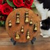 Resin chees pawns on a textured golden-brown decorative wood slice, capturing the strategic beauty of chees in art form.