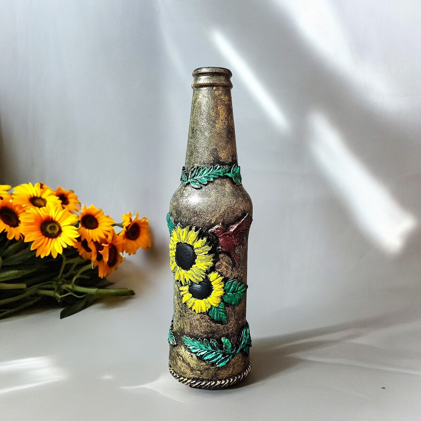 Hand-dcorated sunflower bottle with clay bird embellishments