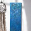 A vertical canvas featuring a raised dream catcher design created with texture paste on a stencil, painted in a vibrant blue with a gold and purple touch, that adds depth and interest