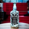 Handcrafted Jack Daniels empty whisky bottle adorned with detailed silver embellishments, including a crown and intricate floral patterns