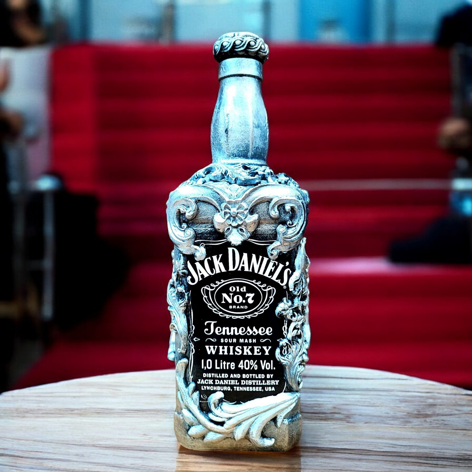 Handcrafted Jack Daniels empty whisky bottle adorned with detailed silver embellishments, including a crown and intricate floral patterns