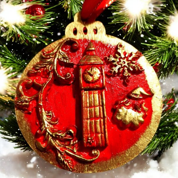 handcrafted Christmas tree ornaments with a red background and gold accents, featuring designs of Big Ben and British crown with holiday motifs.
