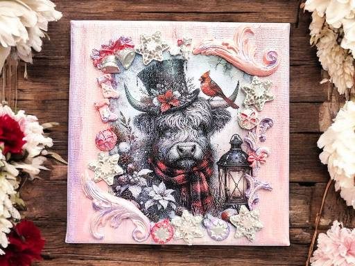6x6'Highland Cow Christmas Canvas Wall Art Square canvas art featuring a festive Higland cow with scarf and top hat, surrounded by air-dry clay embellishments like stars, bells, and leaves, with a background painted in acrylic and metallic colours.