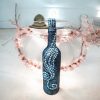 Handcrafted silver decorated bottle with intricate pearl inspired swirl design.