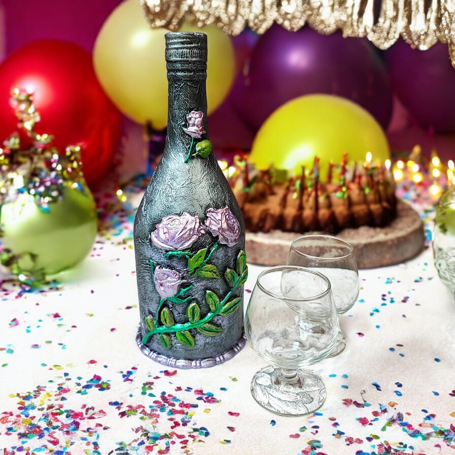 Hand-decored glass bottle with clay embellishments. Painted in silver colour