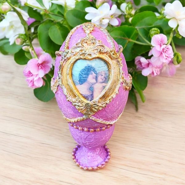 Handcrafted pink decorative egg with gold accents, featuring a romantic Victorian-style image and heart-shaped frame.