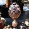 Handcrafted steampunk decorative egg with copper accents, gears, and a vintage-style pedestal base, perfect for home décor or as a unique gift.