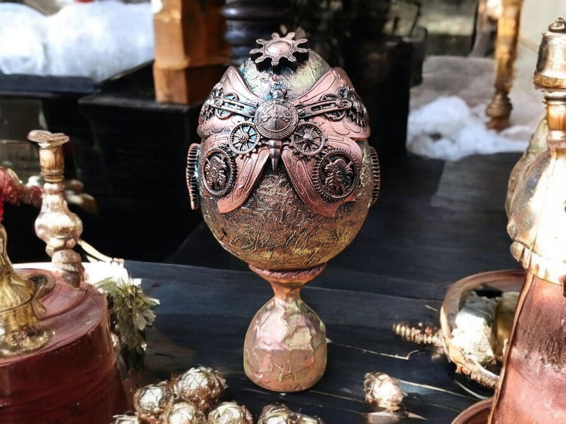 Handcrafted steampunk decorative egg with copper accents, gears, and a vintage-style pedestal base, perfect for home décor or as a unique gift.