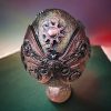 Handcrafted steampunk decorative egg with copper accents, gears, and a vintage-style pedestal base, perfect for home décor or as a unique gift